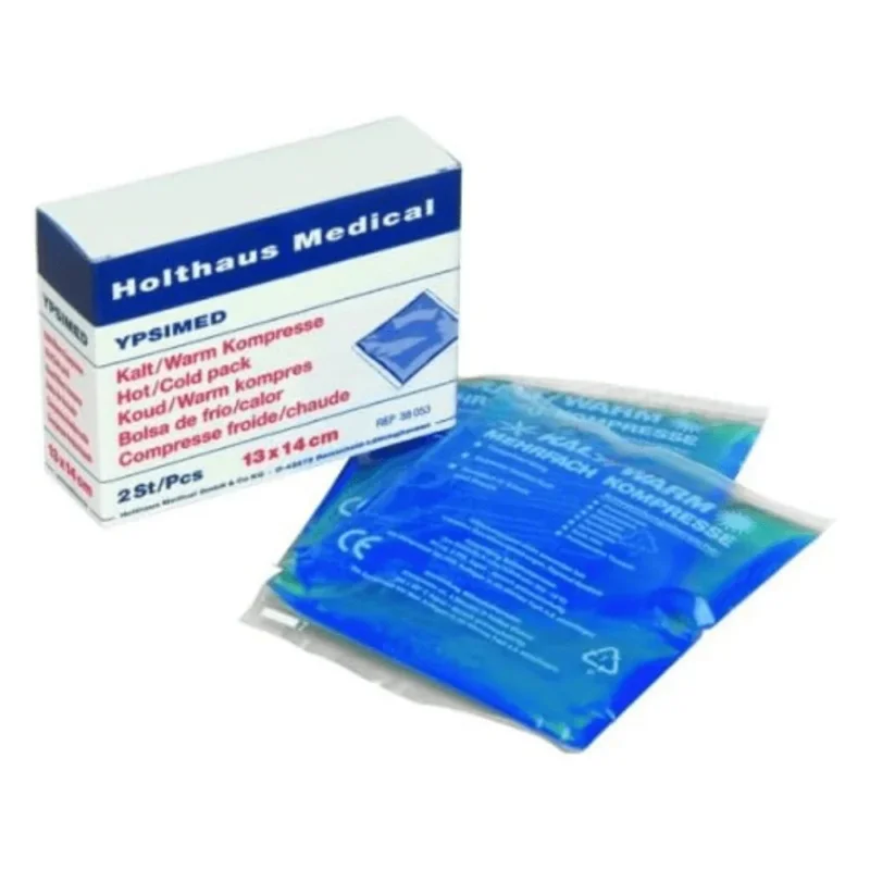 Abgebildet ist eine Schachtel mit der Aufschrift „Holthaus YPSIMED Kalt / Warm Kompresse 13 x 14 cm | Packung (2 Stück)“ von Holthaus Medical GmbH & Co. KG. Darin befinden sich zwei Kompressen, jede 13 x 14 cm groß und in durchsichtiges Plastik eingewickelt, das eine blaue Flüssigkeit enthält. Der Text auf der Schachtel ist mehrsprachig und hebt die Heiß- und Kaltanwendung des Produkts hervor, die in Erste-Hilfe-Situationen unerlässlich ist.